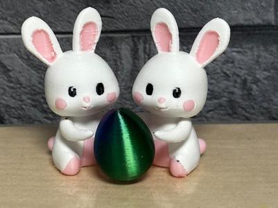Adorable bunnies with egg