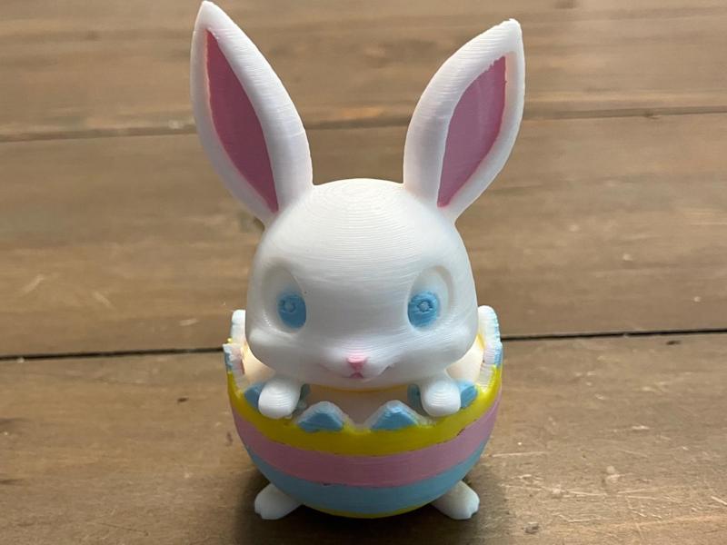 Cute Easter Bunny inside dyed Easter Egg