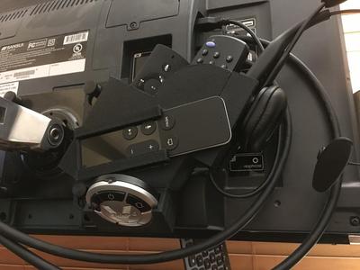 Monitor bracket remote holder and headset charger