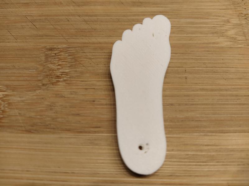 Key ring in the shape of a foot