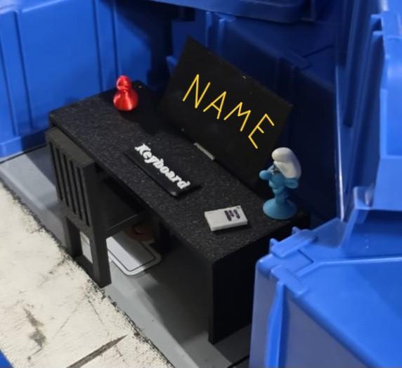 Desk with chair, keyboard, screen and a duck