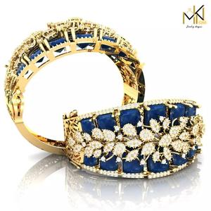 Gold bracelet adorned with blue gemstones and sparkling diamonds