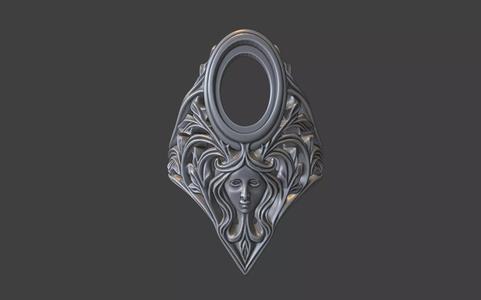 floral scrollwork ring with face and gemstone