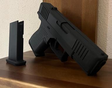 Pistol 19 with movable trigger slide and magazine