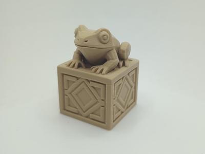 Frog on decorated pedestal