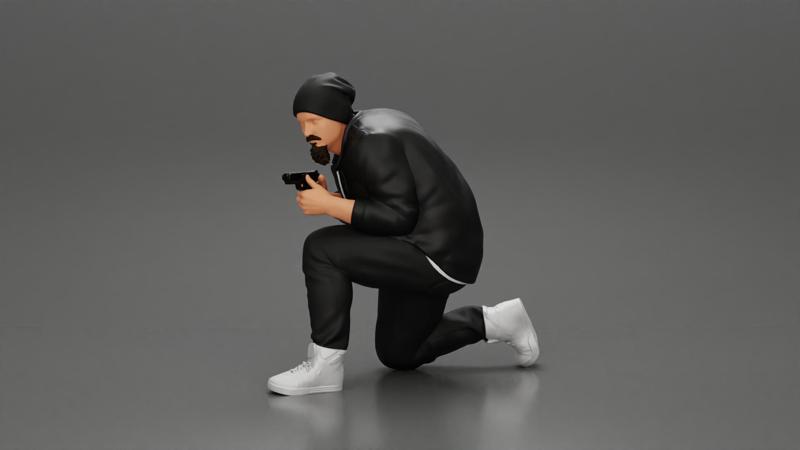 Gangster in hat and jacket sitting and holding a gun hides behind the car