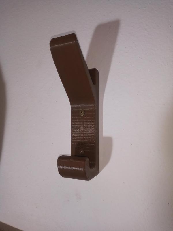 WALL-MOUNTED HELMET HOLDER