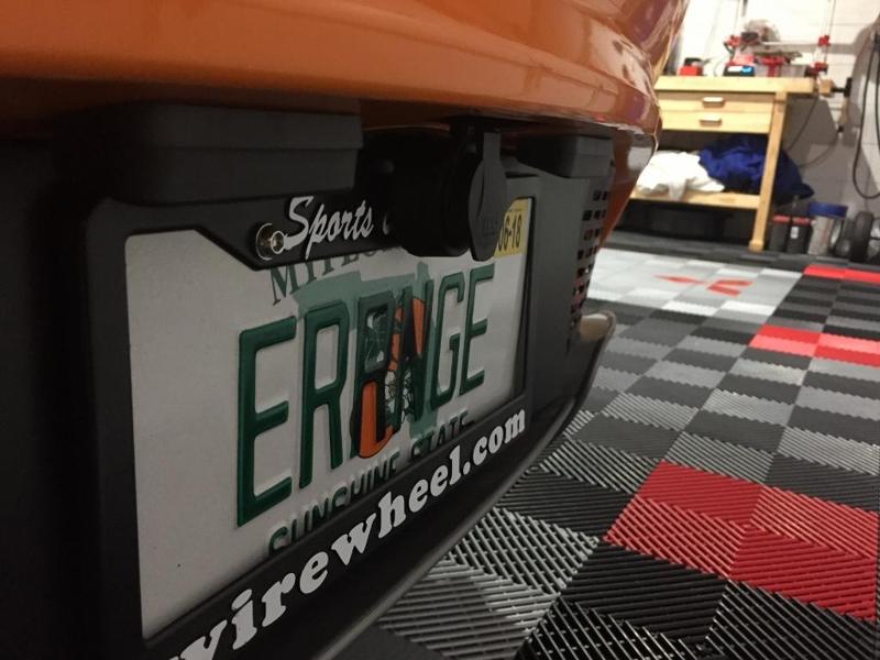 Magnetic trickle charger license plate mount