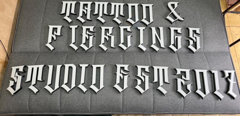 tattoo and piercings studio sign 